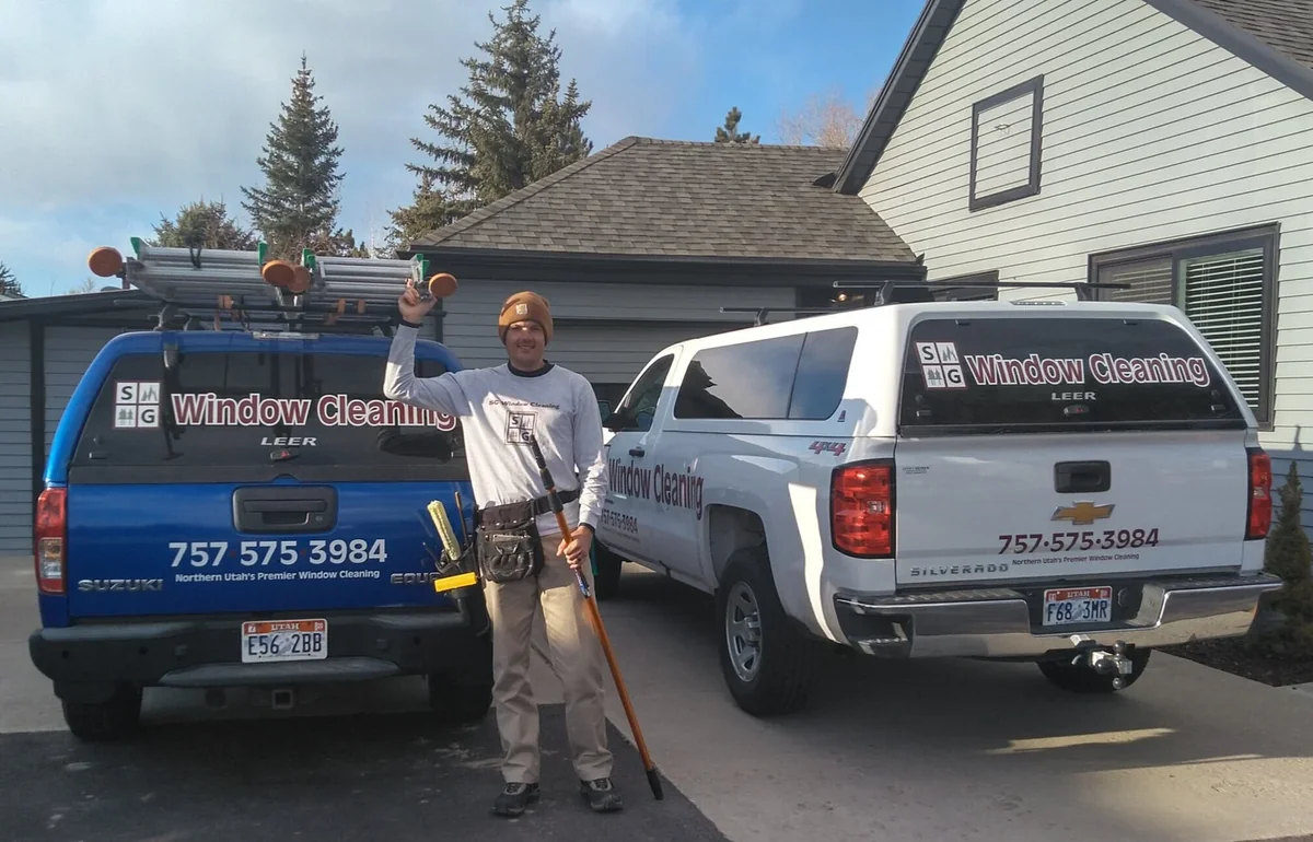 Trevor Banks, owner of SG Window Cleaning, with his service trucks